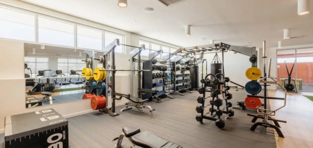 Weights racks punching bags and benches fitness area at Apollo Tempe in Tempe Student Accommodation