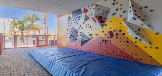 Climbing wall blue mat pool area exterior at Apollo Tempe in Tempe Student Accommodation