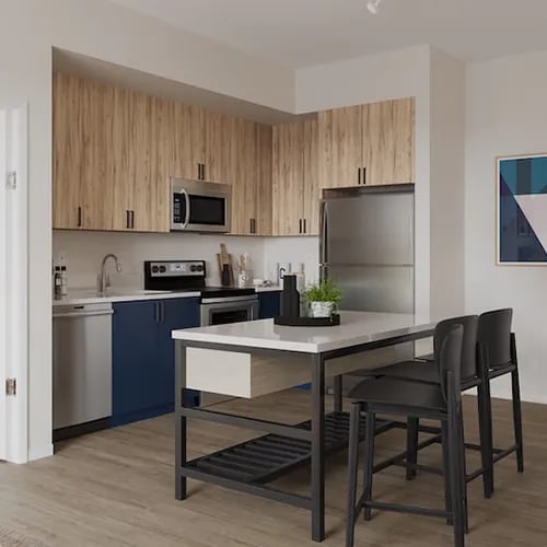 Kitchen island with chairs appliances and cabinets kitchen at Uncommon Boise State in Boise Student Accommodation
