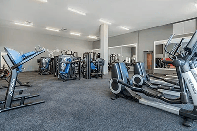 Gym equipment including ellipticals and weight machines gym at Here Kansas in Lawrence Student Accommodation