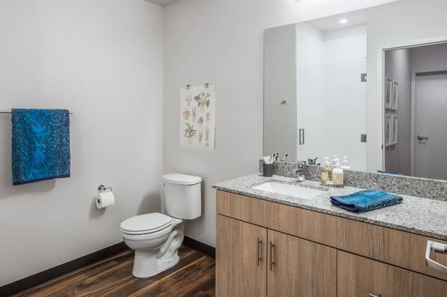 Toilet sink vanity granite countertop blue towel bathroom at Fifteen51 in Reno Student Accommodation