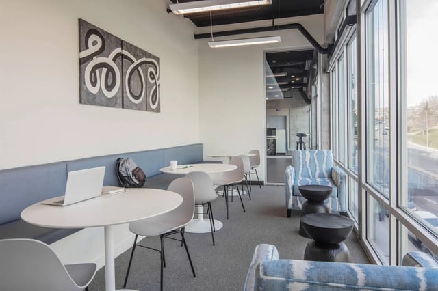 Tables chairs artwork laptop backpack lounge area living room at Fifteen51 in Reno Student Accommodation