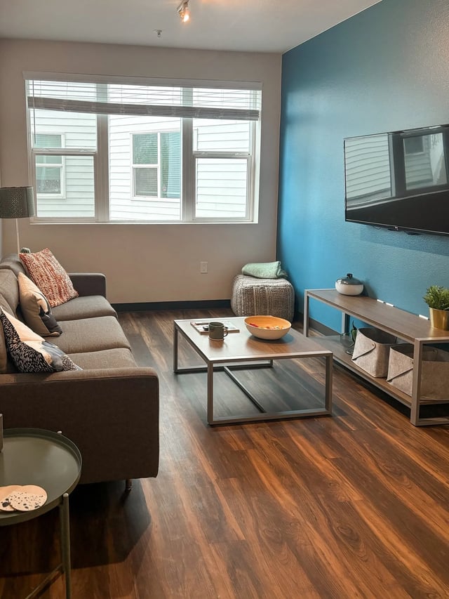 Sofa coffee table ottoman and television living room at Fifteen51 in Reno Student Accommodation