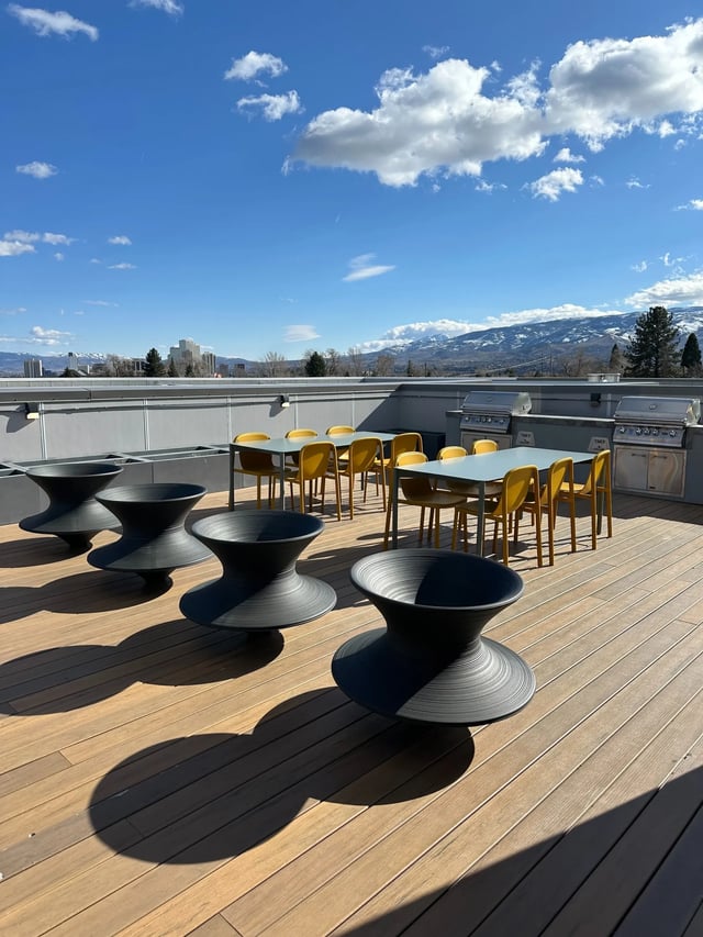 Black chairs tables grills patio area at Fifteen51 in Reno Student Accommodation