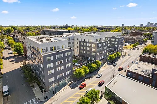 Modern apartment building with cars and trees exterior at Uncommon Columbus in Columbus Student Accommodation