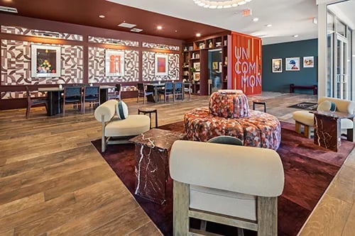 Modern lounge area with chairs and tables at Uncommon Columbus in Columbus Student Accommodation