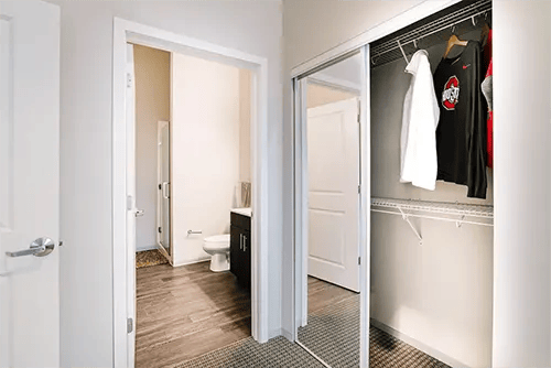 Toilet shower and open closet with clothes Bathroom closet at Uncommon Columbus in Columbus Student Accommodation