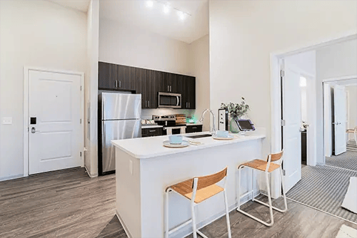 Modern kitchen with island and two stools kitchen at Uncommon Columbus in Columbus Student Accommodation