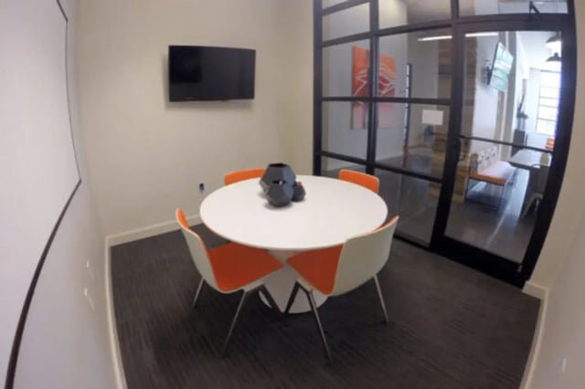 White round table four orange chairs study area at The Knox Apartments in Knoxville Student Accommodation