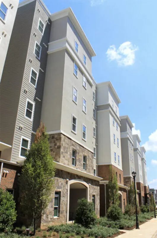 Apartment building exterior with stone and siding exterior at The Knox Apartments in Knoxville Student Accommodation