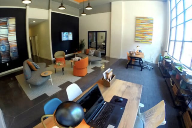 Modern lounge with seating and study desk living room at The Knox Apartments in Knoxville Student Accommodation