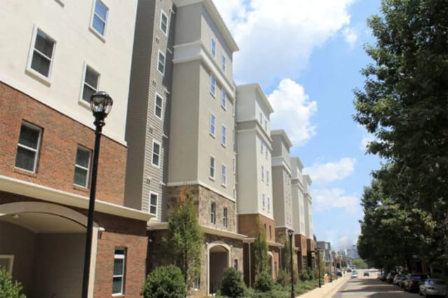 Apartment buildings with brick and stucco exterior Exterior at The Knox Apartments in Knoxville Student Accommodation