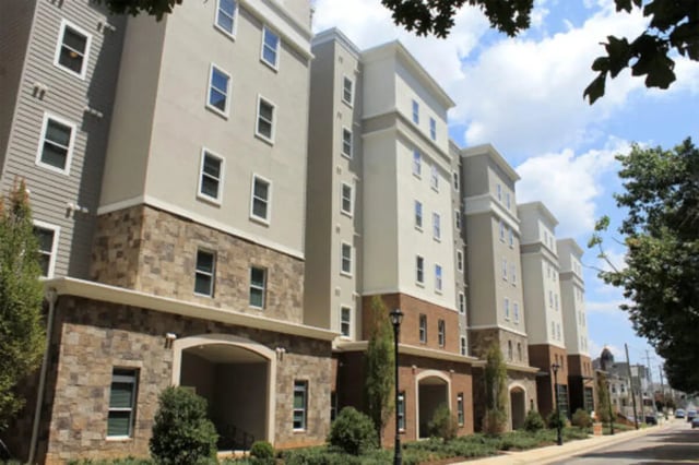 Apartment building with stone and beige facade exterior at The Knox Apartments in Knoxville Student Accommodation