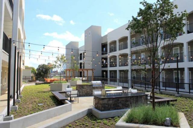 Courtyard with grills seating string lights exterior at The Knox Apartments in Knoxville Student Accommodation