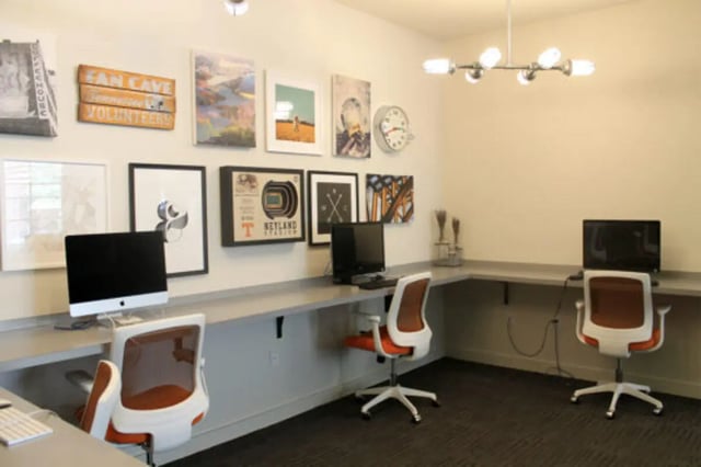 Computers chairs artwork on wall study area at The Knox Apartments in Knoxville Student Accommodation