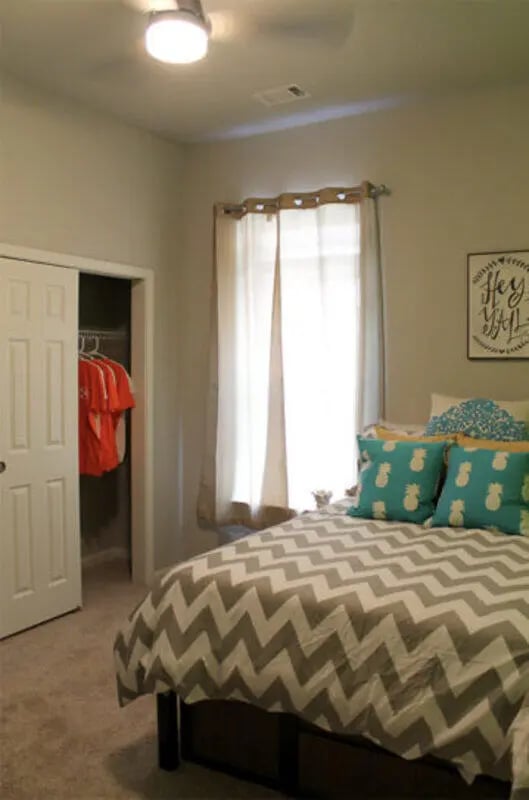 Chevron comforter pineapple pillows open closet bedroom at The Knox Apartments in Knoxville Student Accommodation