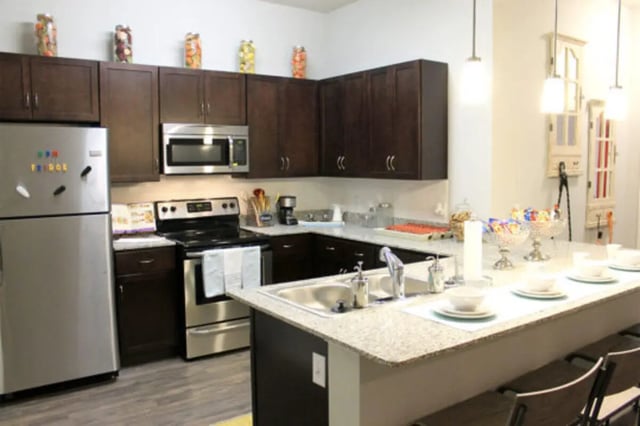 Stainless steel fridge microwave and stove kitchen at The Knox Apartments in Knoxville Student Accommodation