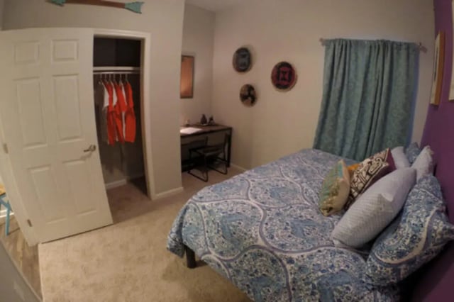 Bed with patterned bedding and pillows study area bedroom at The Knox Apartments in Knoxville Student Accommodation