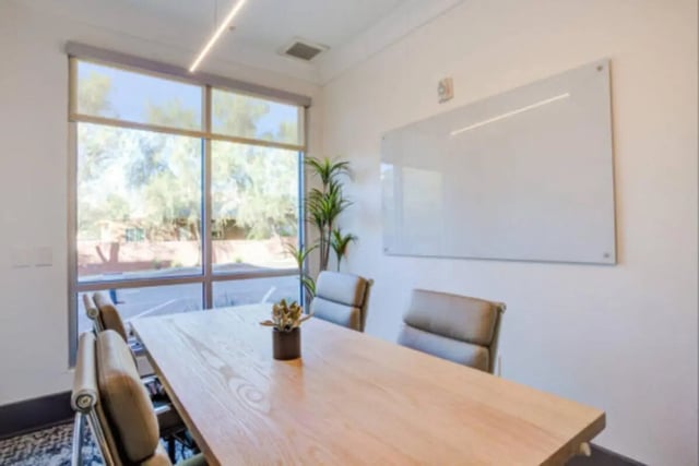 Table chairs whiteboard large window study area at The District on 5th in Tucson Student Accommodation