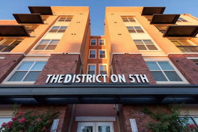Building exterior with windows and nameplate exterior at The District on 5th in Tucson Student Accommodation