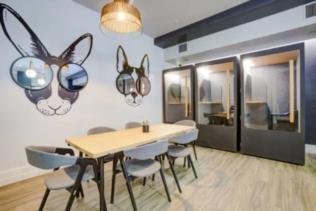 Table with chairs near study pods Common area at The District on 5th in Tucson Student Accommodation