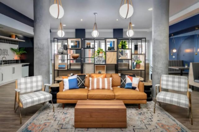 Leather sofa patterned chairs shelving unit living room at The District on 5th in Tucson Student Accommodation