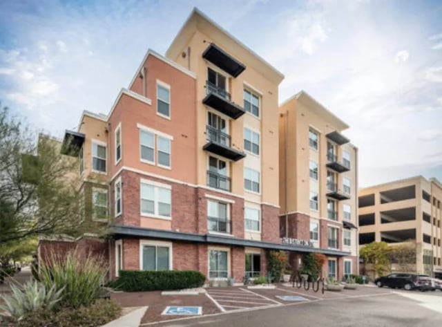 Modern apartment building with balconies and parking exterior at The District on 5th in Tucson Student Accommodation