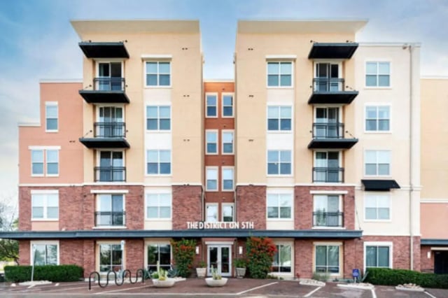 Multi-story building with balconies and red brick exterior exterior at The District on 5th in Tucson Student Accommodation