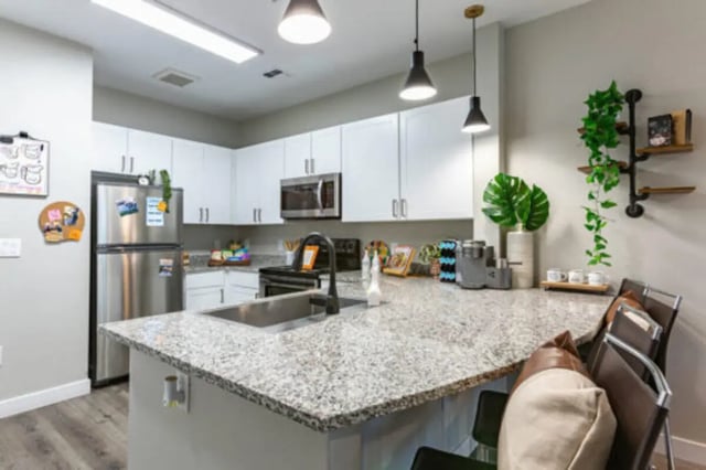 Modern kitchen with stainless steel appliances and island kitchen at The District on 5th in Tucson Student Accommodation