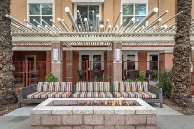 Striped sofas surround outdoor fire pit exterior at The District on 5th in Tucson Student Accommodation