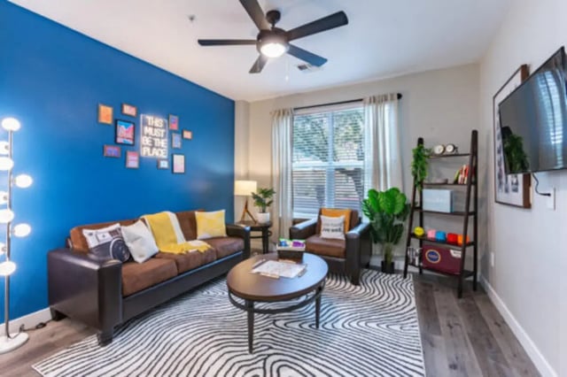 Brown sofa table chairs rug living room at The District on 5th in Tucson Student Accommodation