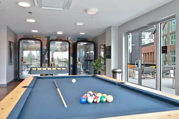 Pool table foosball pods and outdoor seating area amenity space at ANOVA Aggie Square in Sacramento Student Accommodation