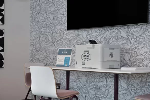 Printer and sign on table study area at ANOVA Aggie Square in Sacramento Student Accommodation