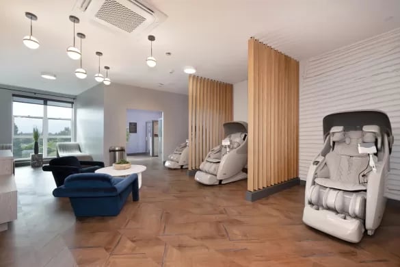Massage chairs and seating area common room at ANOVA Aggie Square in Sacramento Student Accommodation