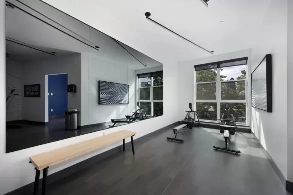 Rowing machines and bench gym equipment at ANOVA Aggie Square in Sacramento Student Accommodation