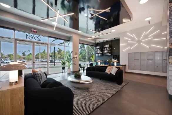 Modern lounge with black sofas and mailboxes lobby at ANOVA Aggie Square in Sacramento Student Accommodation