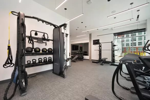 Gym equipment weights and machines Fitness room at ANOVA Aggie Square in Sacramento Student Accommodation