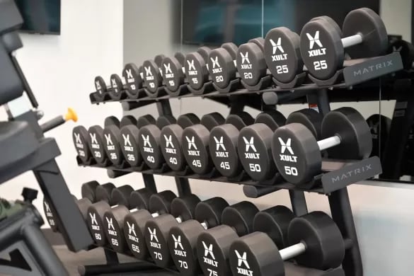 Dumbbells on racks fitness equipment gym at ANOVA Aggie Square in Sacramento Student Accommodation
