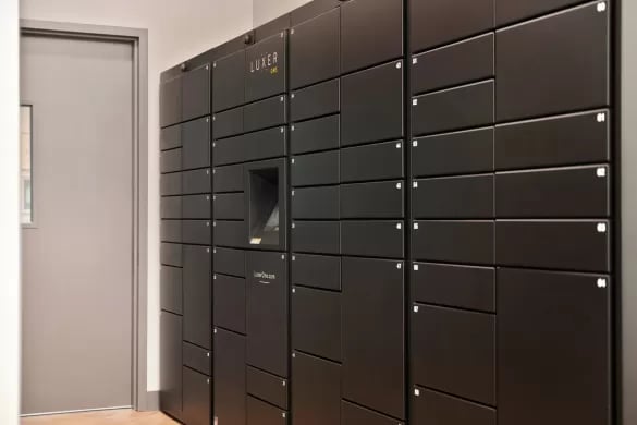 Black Luxor One lockers with digital interface interior common area at ANOVA Aggie Square in Sacramento Student Accommodation