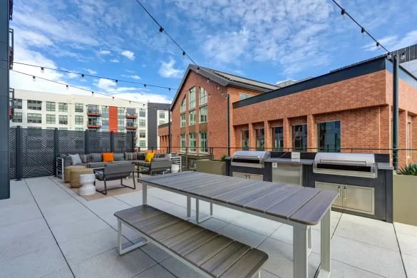 Outdoor patio furniture and grills exterior at ANOVA Aggie Square in Sacramento Student Accommodation