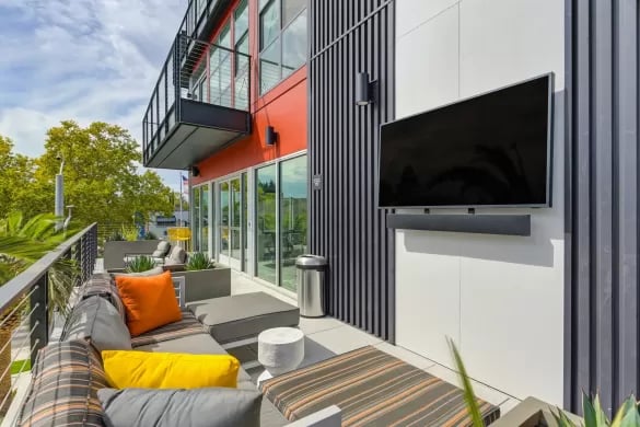 Outdoor lounge seating with TV and tables Patio at ANOVA Aggie Square in Sacramento Student Accommodation