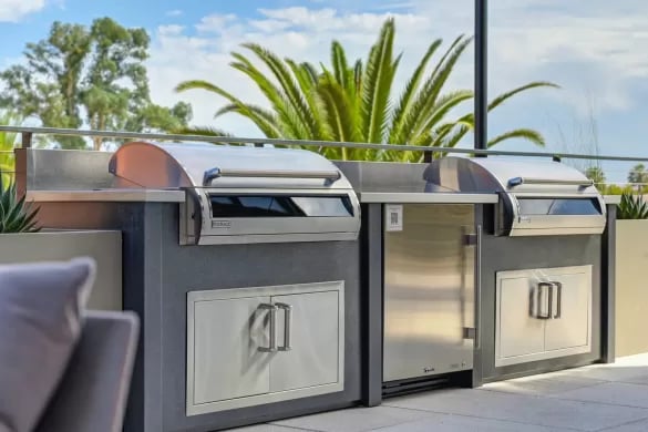 Outdoor kitchen with two grills and refrigerator outdoor kitchen at ANOVA Aggie Square in Sacramento Student Accommodation