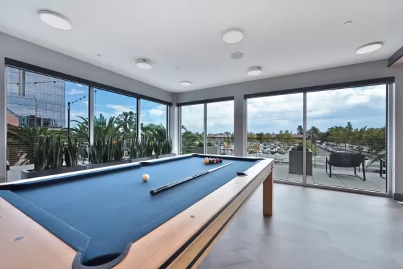 Pool table with balls and cues playing area at ANOVA Aggie Square in Sacramento Student Accommodation