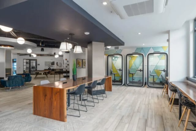 Long wooden table glass pods and chairs communal area at ANOVA uCity Square in Philadelphia Student Accommodation