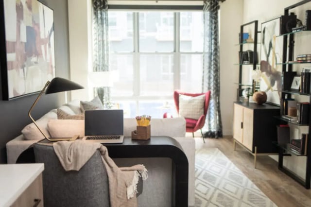 Desk, laptop, sofa, chair, artwork, living room at ANOVA uCity Square in Philadelphia Student Accommodation