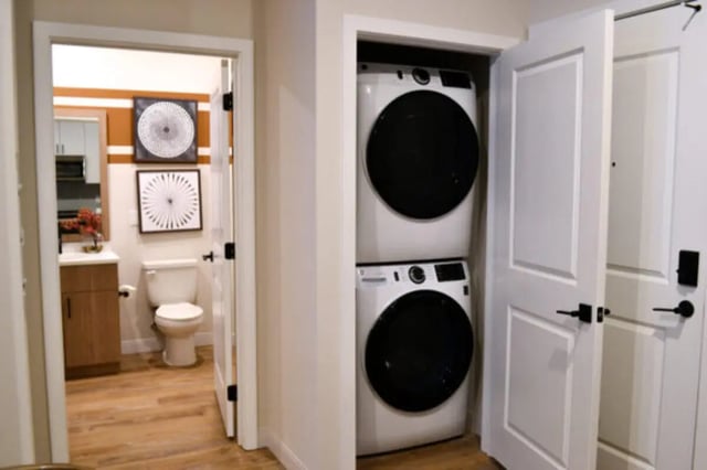Stacked washer dryer visible near bathroom and doors Laundry room at ANOVA uCity Square in Philadelphia Student Accommodation