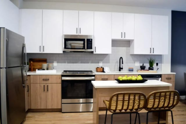 Modern kitchen with stainless steel appliances and island kitchen at ANOVA uCity Square in Philadelphia Student Accommodation