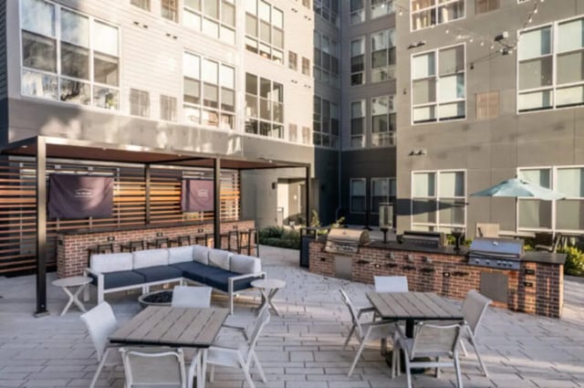 Outdoor lounge area with grills seating patio exterior at ANOVA uCity Square in Philadelphia Student Accommodation