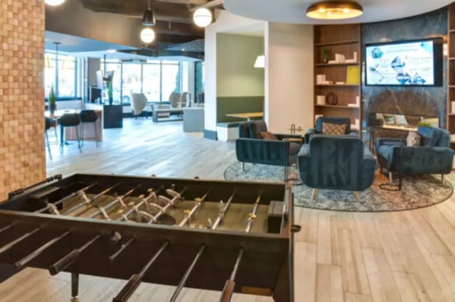 Foosball table lounge area with couches and television common area at ANOVA uCity Square in Philadelphia Student Accommodation