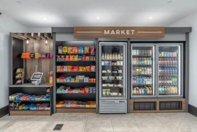 Snack shelves and refrigerators with drinks Market Area at ANOVA uCity Square in Philadelphia Student Accommodation